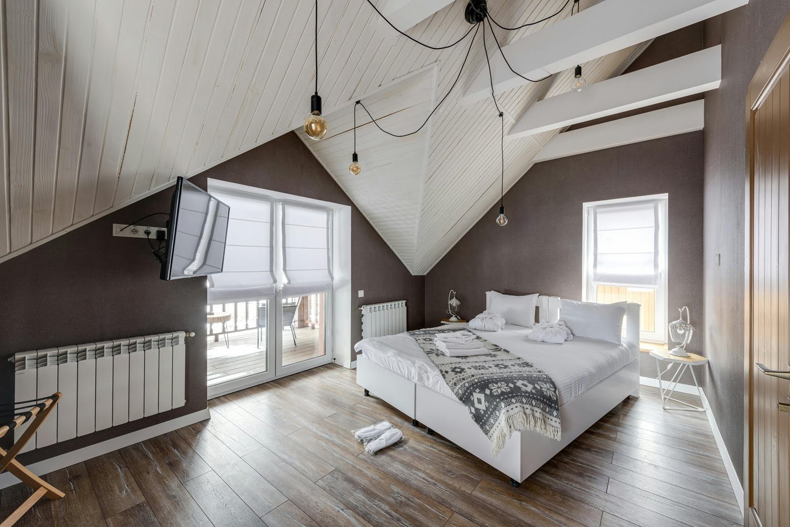 Bright eco-friendly Airbnb bedroom with natural light, wooden flooring, and minimalist sustainable interior design