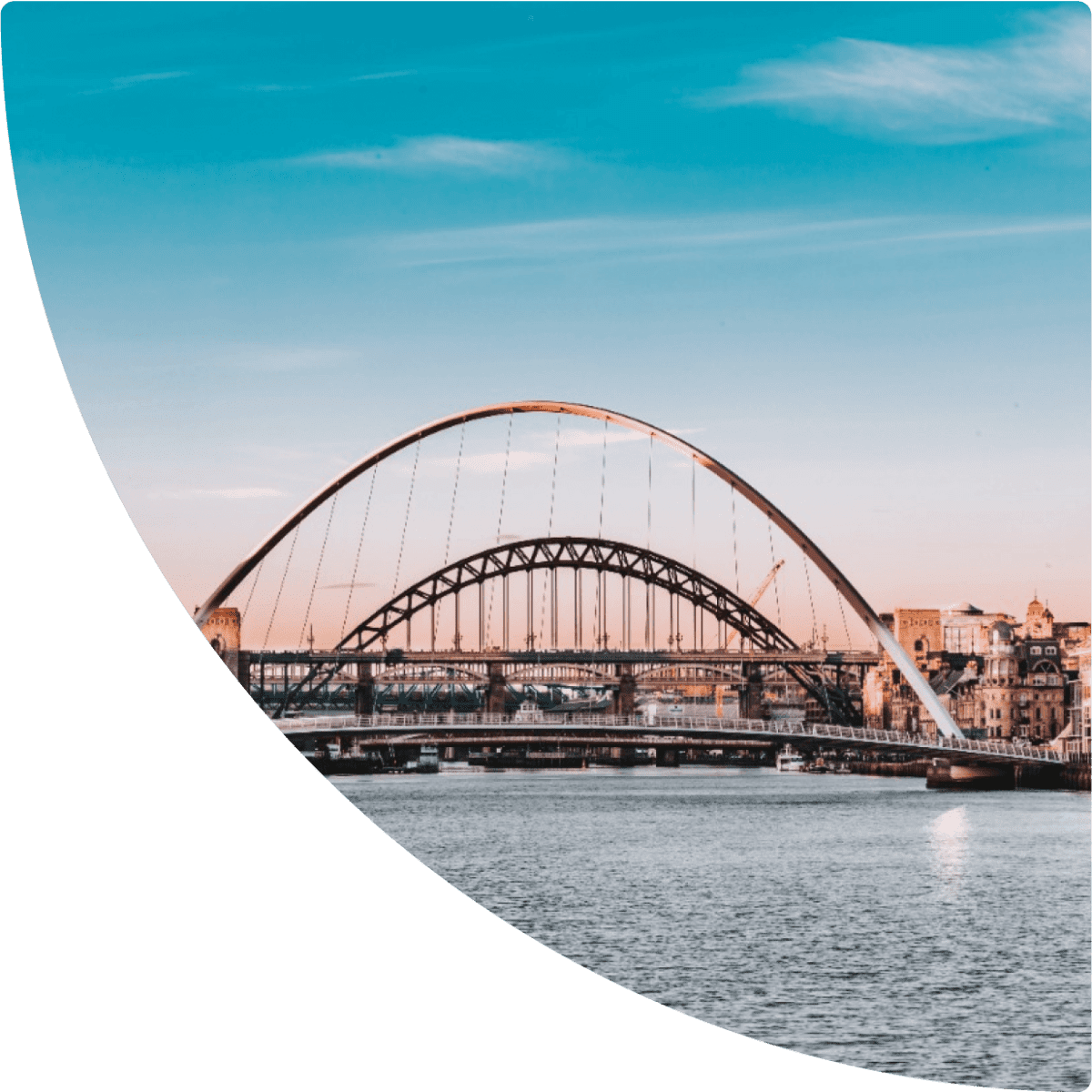 a bridge over water with buildings in the background