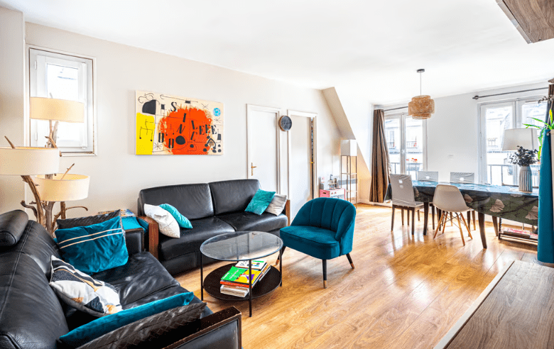 a living room with a table and chairs
