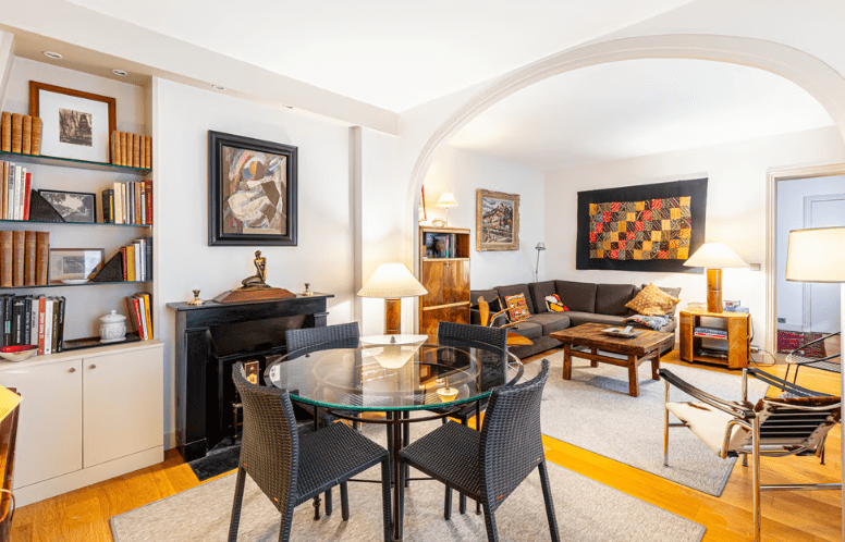 a living room with a glass table and chairs