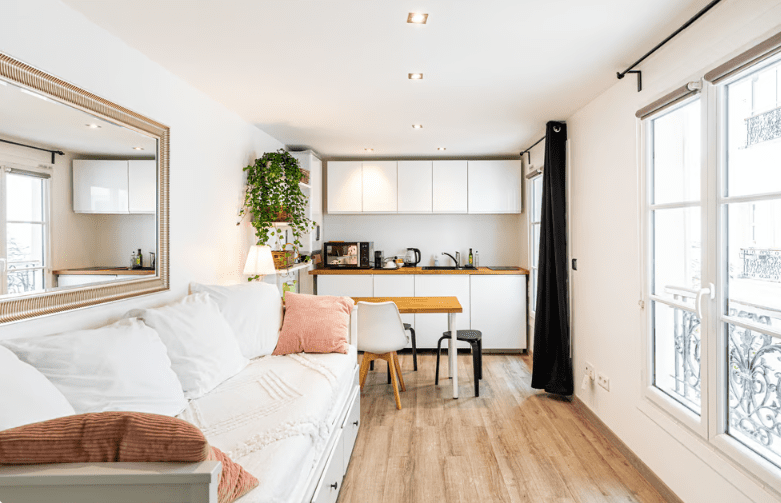 a room with a couch and kitchen