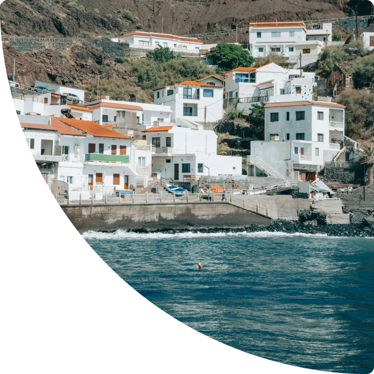 White houses with red roofs by the sea, at the foot of a hillside - La Gomera, GuestReady