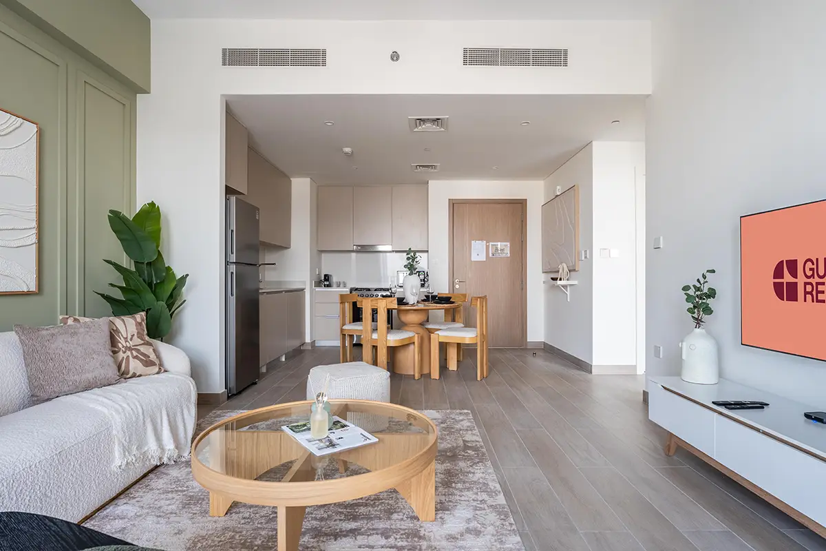 Bright modern apartment with open-plan living room, dining table, and kitchen in neutral tones - Airbnb management in Lanzarote
