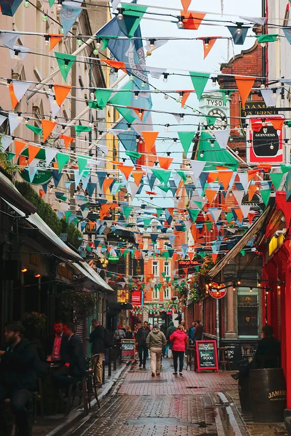 Lively Dublin street with colourful flags and busy pubs, short-term letting regulations in dublin
